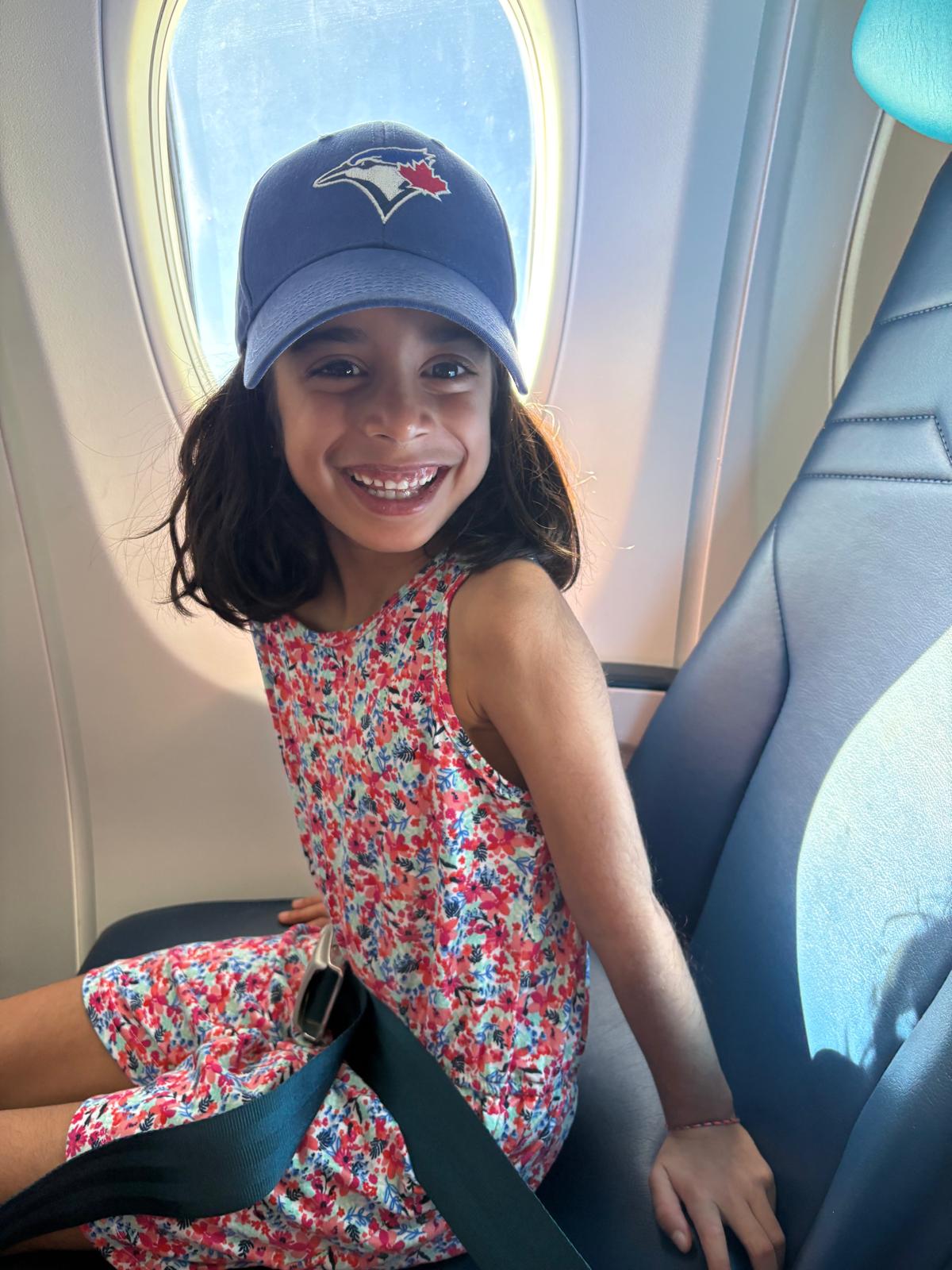 Isa smiling in a pink dress.